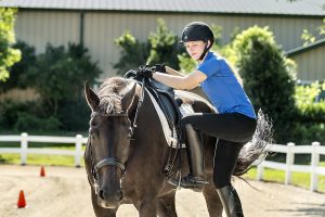 MTSU junior integrated studies major and Honors College Buchanan Fellow Meghan Miller mounts “Remy,” the horse she will ride in this week’s North American Junior and Young Rider Championships in Parker, Colorado. (MTSU photo by J. Intintoli)