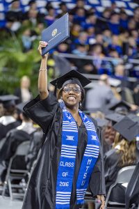 A new MTSU graduate holds her hard-earned degree sky-high to show family and friends while returning to her seat at Murphy Center during the university’s summer 2016 commencement ceremony Saturday, Aug. 6, in Murphy Center. (MTSU photo by J. Intintoli)