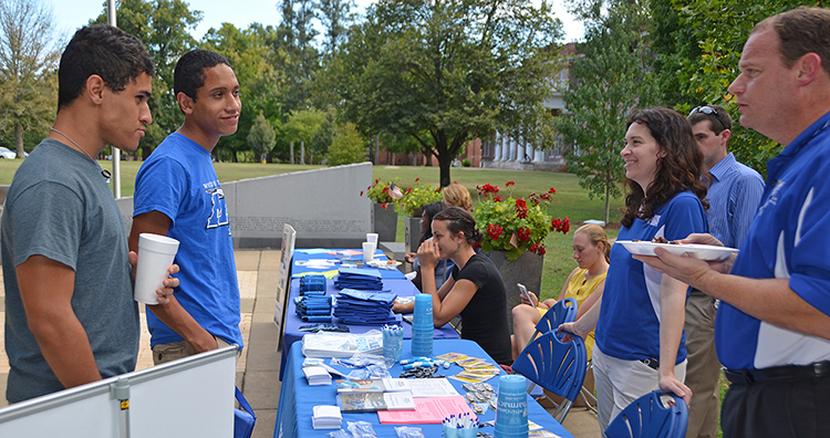 Zachary Lopez, left, and MTSU freshman biology major Rafael Lopez of Readyville, Tennessee, learn about Health Services and Health Promotions offerings from Rick Chapman, right, and Lisa Schrader Aug. 17 near the Military Memorial site outside the Tom H. Jackson Building. They attended the newcomer briefing held by the Charlie and Hazel Daniels Veterans and Military Family Center. (MTSU photo by Randy Weiler)
