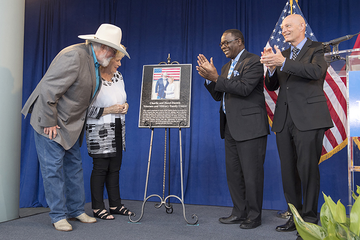 Charlie and Hazel Daniels, left, view the metal plaque given by MTSU acknowledging their gifts and those from The Journey Home Project for the Charlie and Hazel Daniels Veterans and Military Family Center named in their honor. Celebrating the moment with them are MTSU President Sidney A. McPhee, second from right, and Keith M. Huber, senior adviser for veterans and leadership initiatives. (MTSU photo by Andy Heidt)