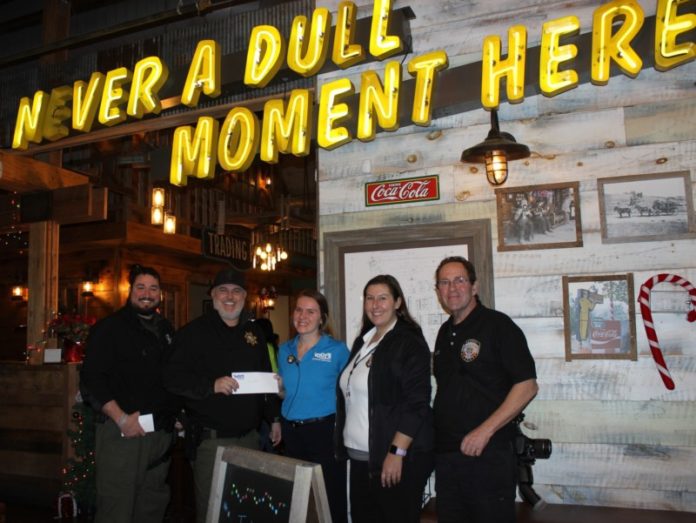 General Manger Alex Fait of Toot’s West presents a corporate donation for Shop with the Sheriff to SRO Sgt. Dustin Cox. At left is SRO T.J. Hinson and at right are Treasurer Libby Stark and President Kedric Rutz of the Sheriff’s Citizens Academy Alumni Association.