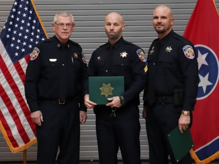 Sheriff Mike Fitzhugh, left, awards the Medal of Valor to Sgt. Jonathan McGee and Deputy Kyle Grisham