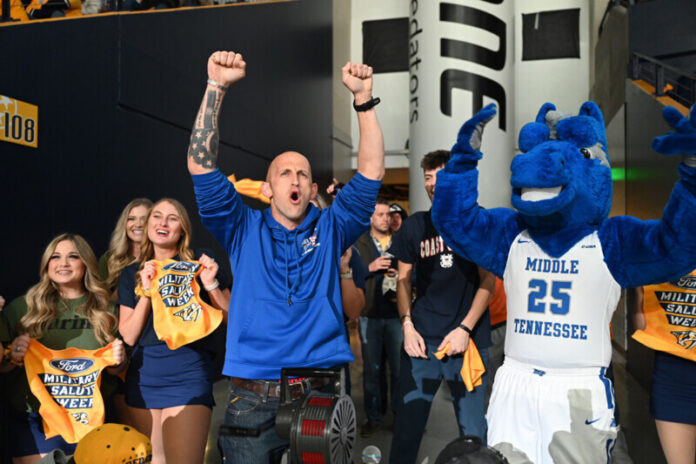 With the full support of Middle Tennessee State University mascot Lightning, right, and others, then-MTSU ROTC cadet Chris Boykin expresses satisfaction from completing an elliptical machine promotional activity during the Nashville Predators’ game that featured MTSU Night/Military Appreciation in March 2023. MTSU students, alumni, veterans and fans return to Bridgestone Arena at 7 p.m. Tuesday, March 19, for special events connected to the Predators’ NHL game against the visiting San Jose Sharks. Commissioned as a second lieutenant, Boykin was assigned to perform engineering work with the U.S. Army’s 101st Airborne at Fort Campbell, Ky. (MTSU file photo by James Cessna)